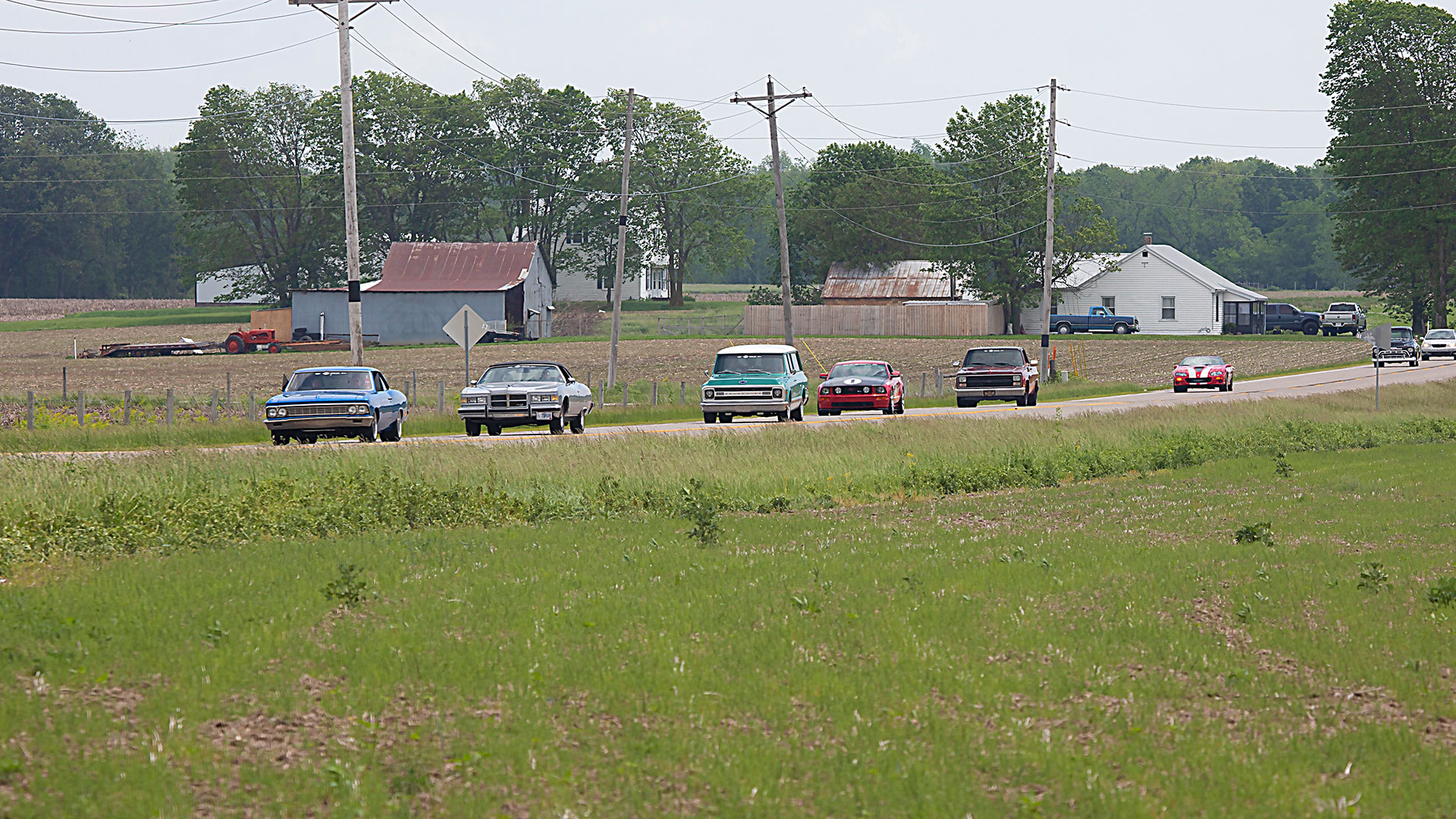 Classic cars driving through rural America