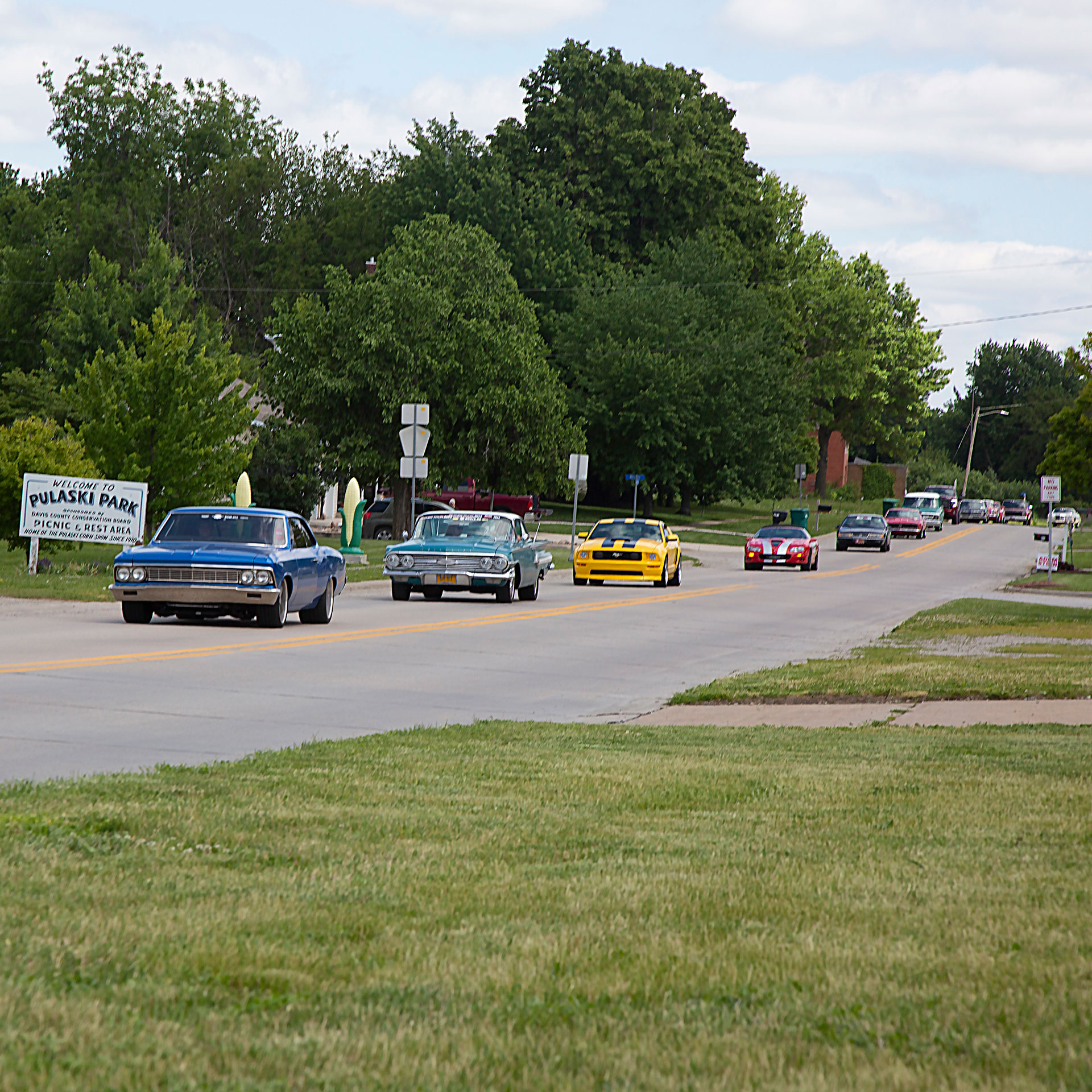 Classic cars driving through Pulaski, Iowa, on Pavement Pounder Events