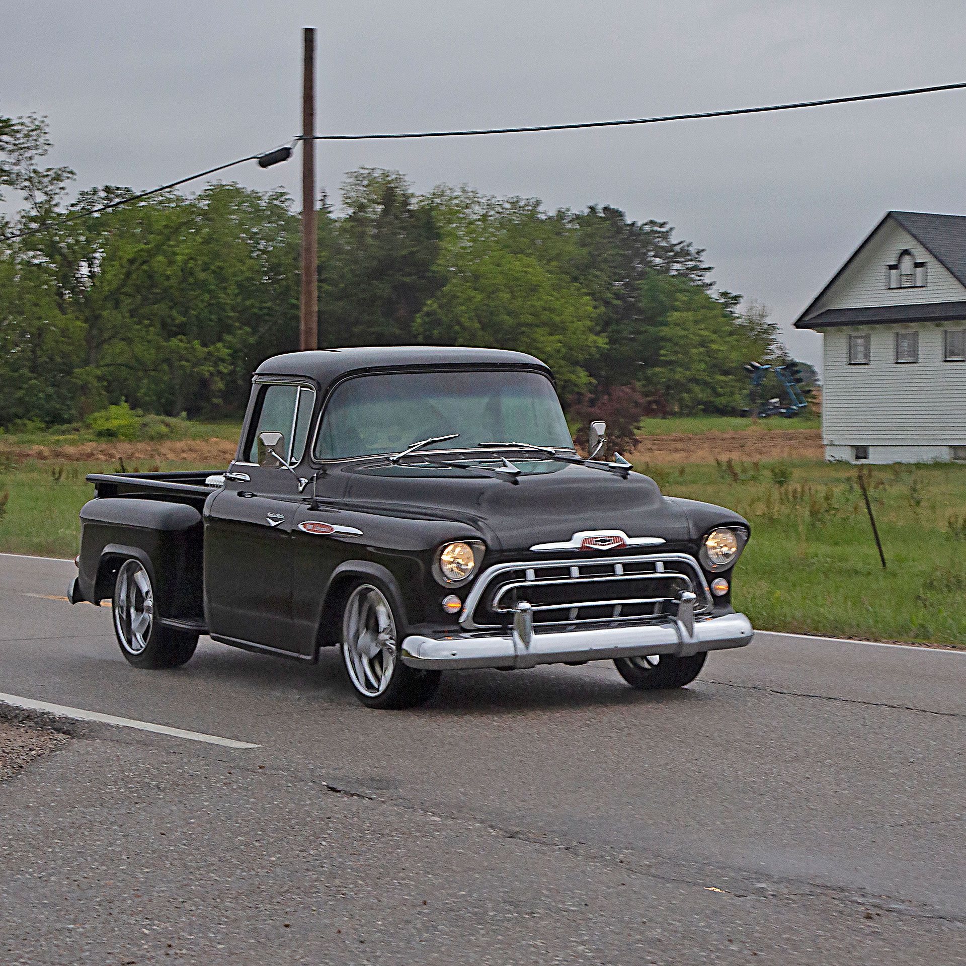1957 Chevrolet truck driving in the rain